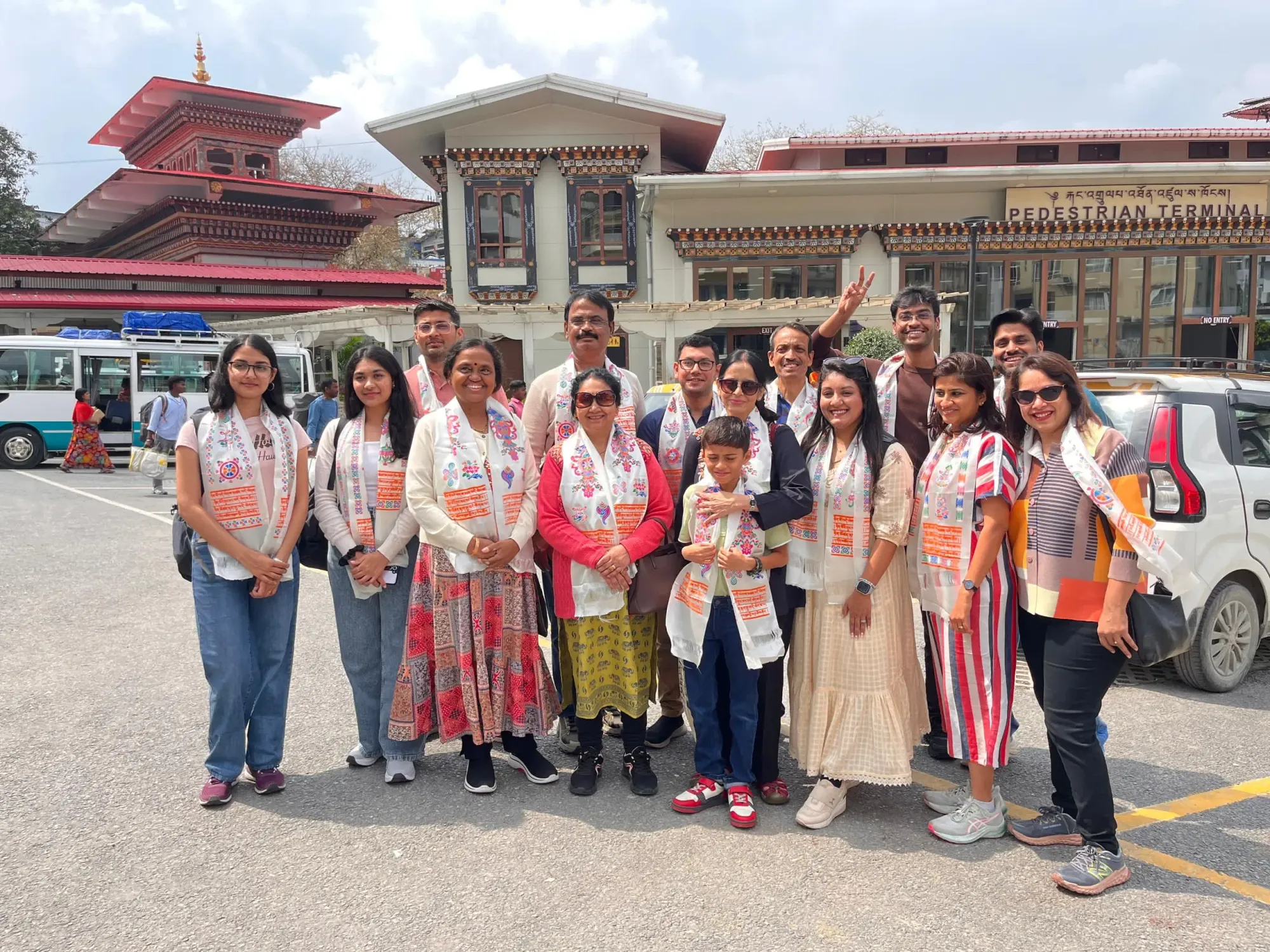 Group of Indian travellers posing together at the Bhutan border area.