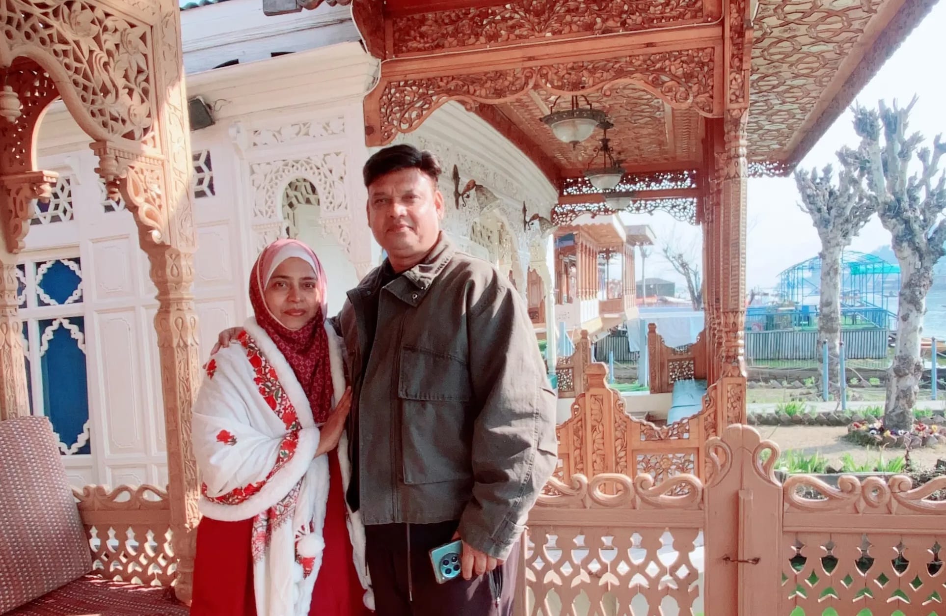 Farheen and her husband at a carved wooden houseboat stay in Kashmir
