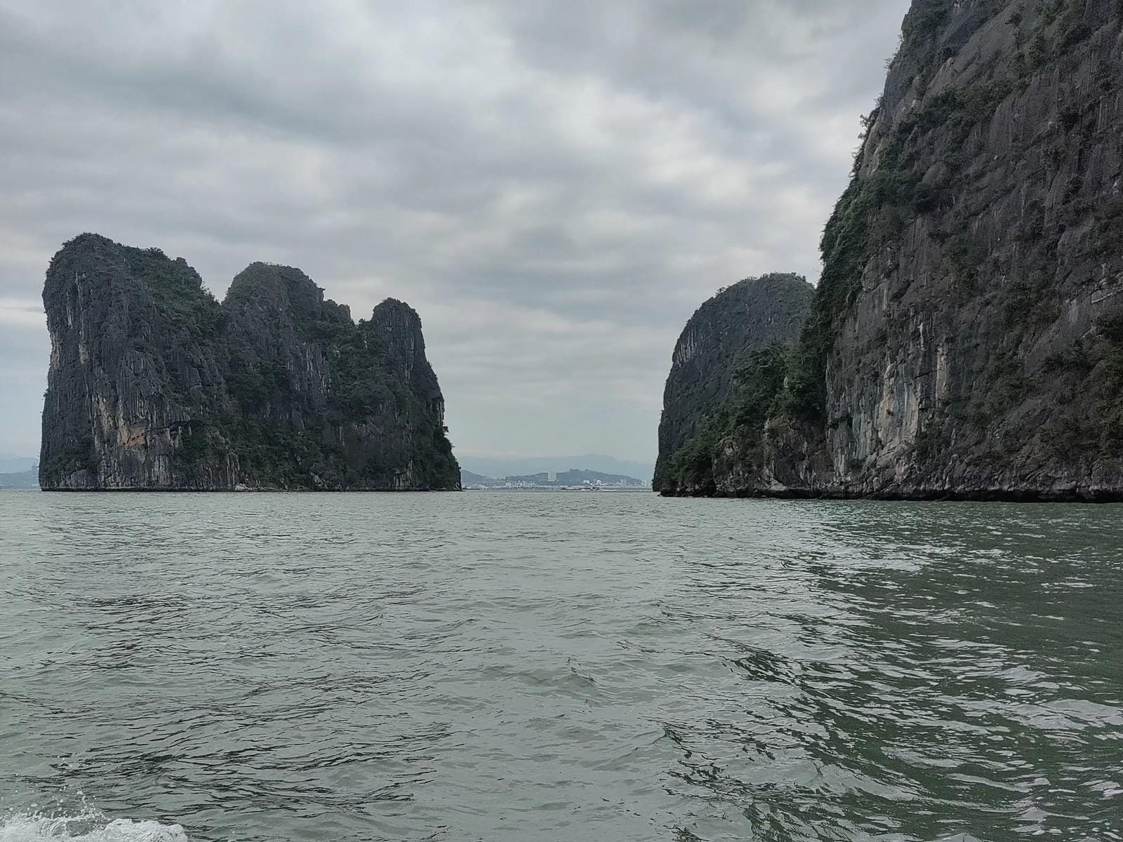 Limestone karsts rising out of the bay, seen from the cruise deck.