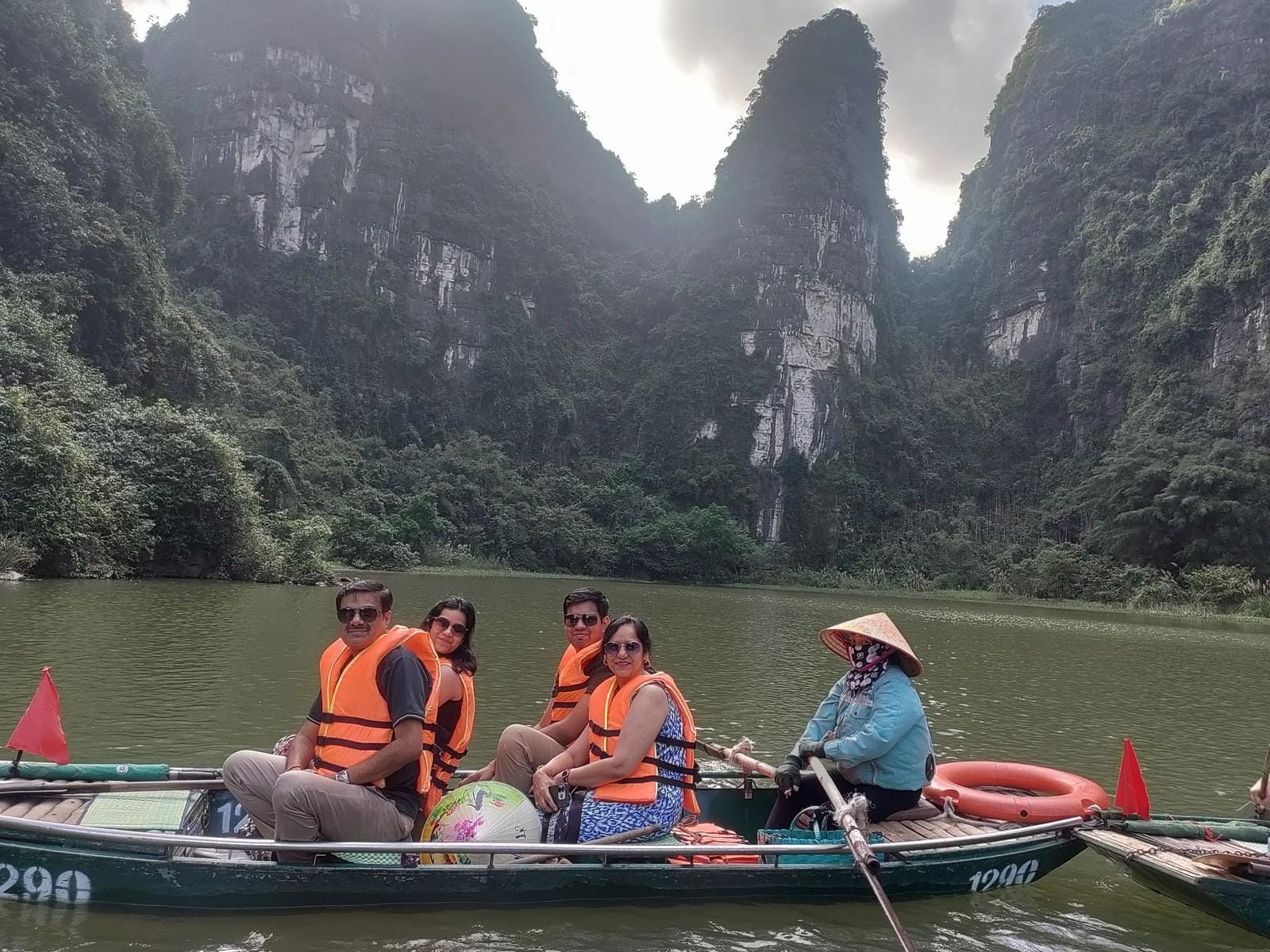 The Chola family on a Trang An rowboat in Ninh Binh.